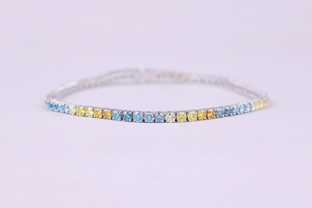 Colorful gemstone bracelet with blue and yellow stones.